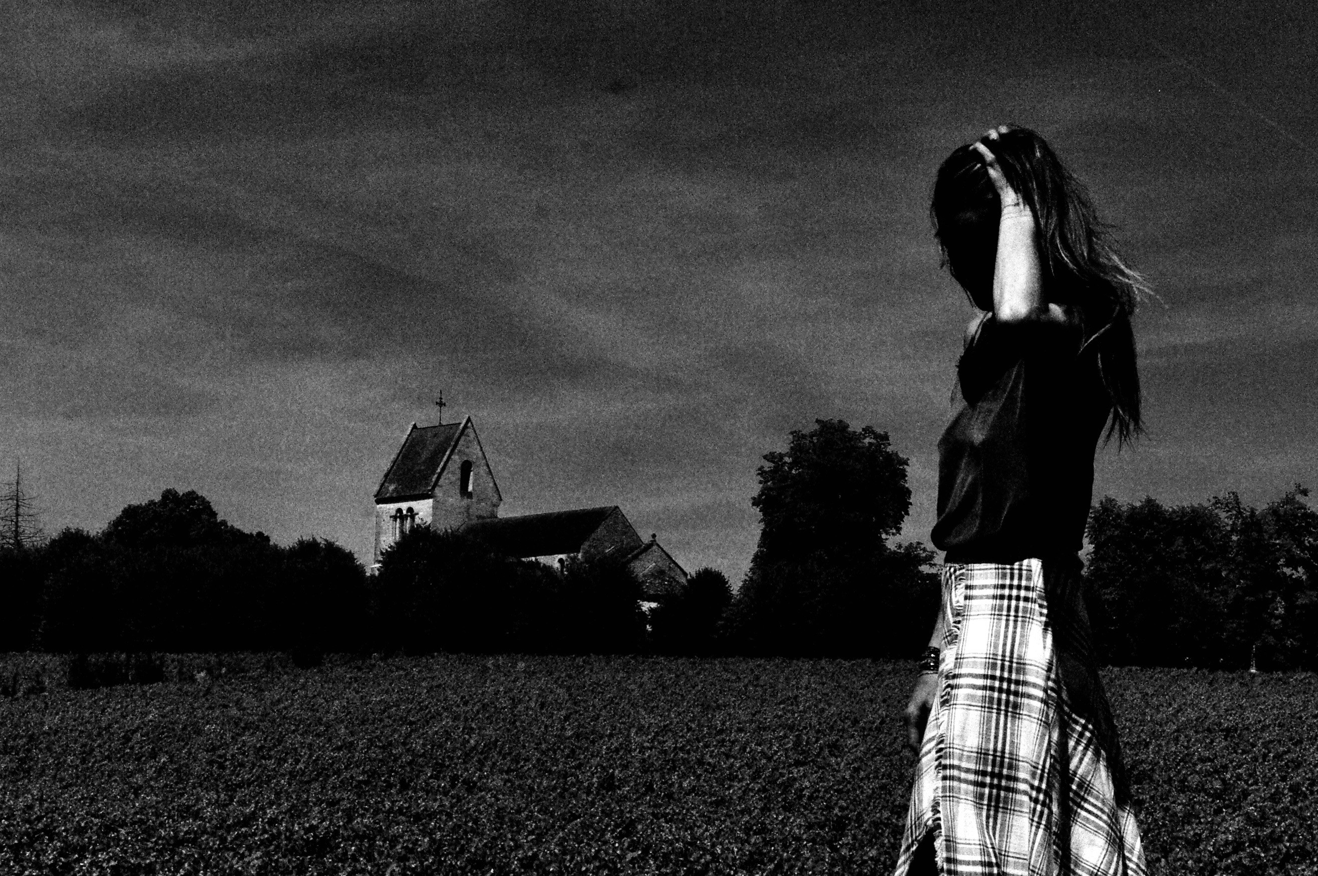 In the field, the village church behind